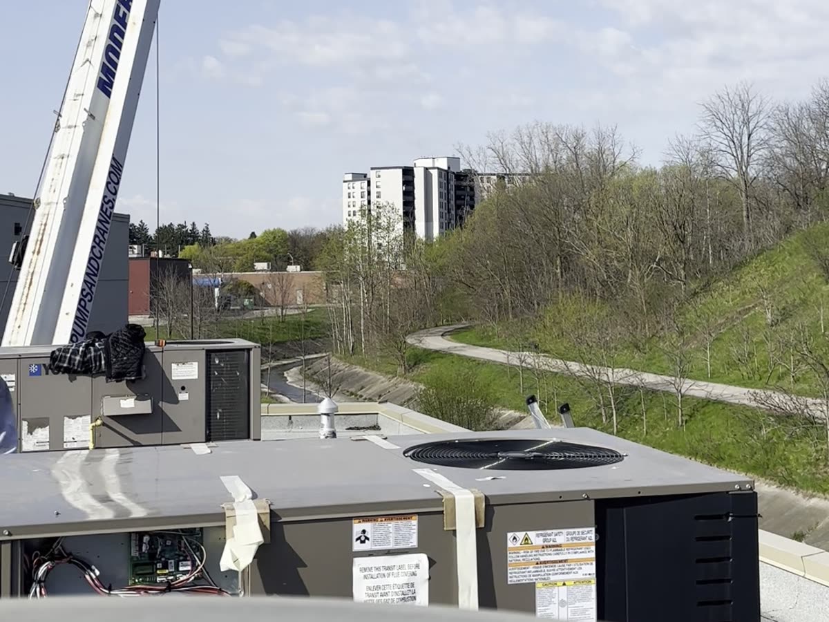 New commercial rooftop unit installed by Q Techub with crane in background